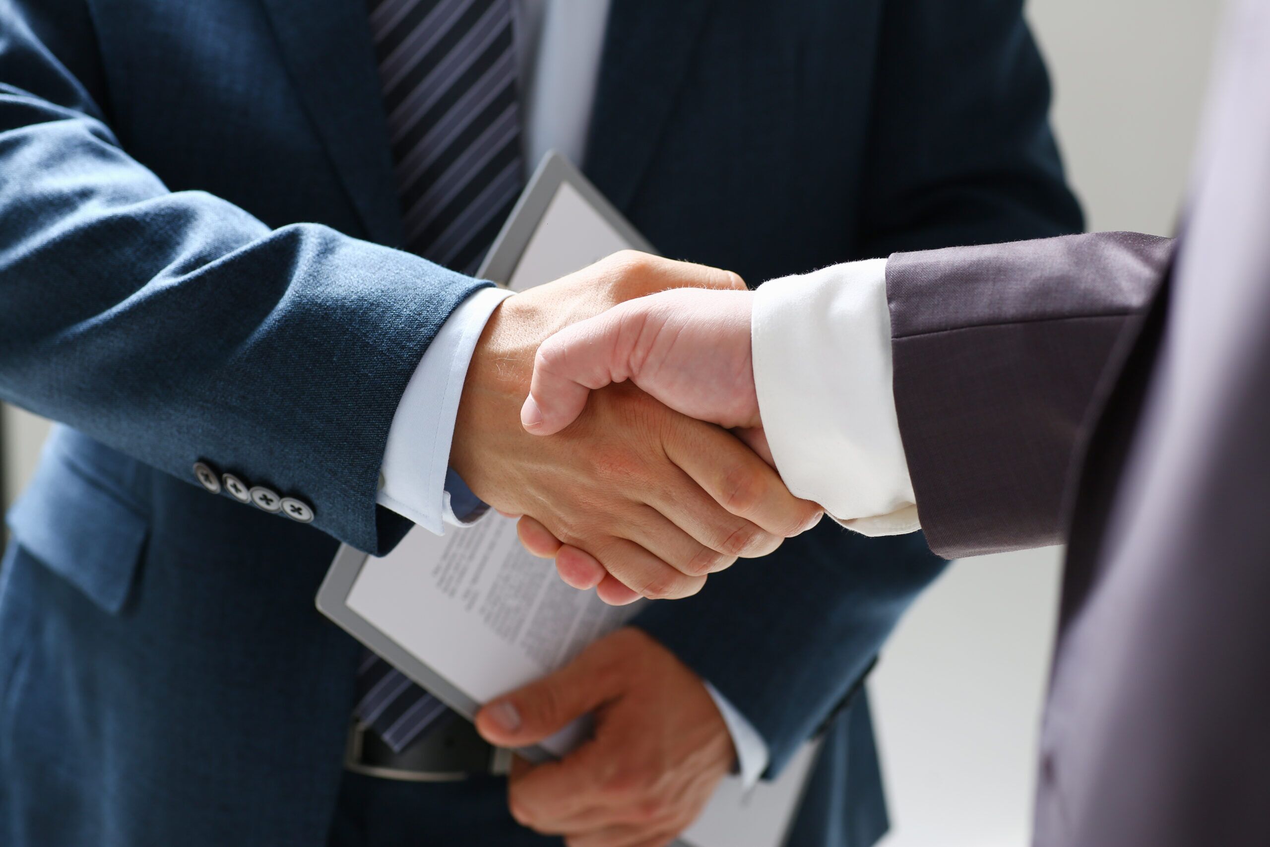 Man,In,Suit,Shake,Hand,As,Hello,In,Office,Closeup.